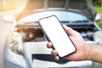 male hand holding a black smartphone with a white touch screen Call an insurance company or a mechanic for help. Because he had an accident or the car engine broke down. car insurance