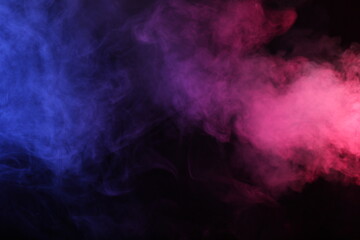 Artifiacial magic smoke in red-blue light on black background