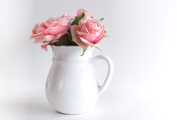 Spring, summer still life scene. Vintage wedding feminine styled photo, floral composition. Bouquet of pink roses in a white vase.