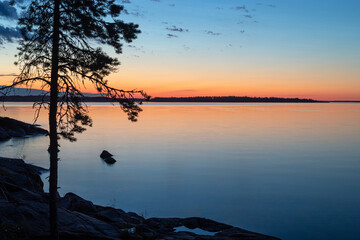 Sunrise over the lake. View of Lake Ladoga in the early morning at dawn. Long exposure time.