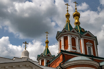 Fototapeta na wymiar Cross-driven cathedral in Kolomna Kremlin from red bricks with golden domes and crosses. Russian Orthodox Church