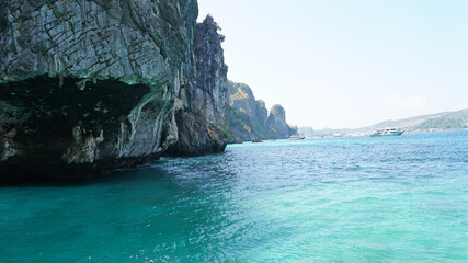 A large cave with hanging stalactites. Viking cave in Thailand. Turquoise clear water. Large blocks...