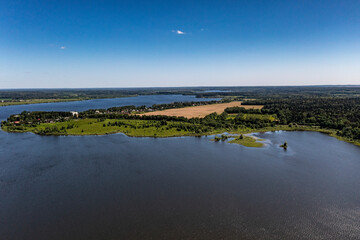 panoramic view from the drone to the village of a large lake and forest and fields and roads 