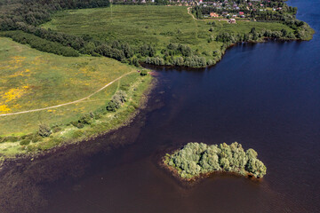 panoramic view from the drone to the village of a large lake and forest and fields and roads 