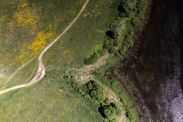 panoramic view from the drone to the village of a large lake and forest and fields and roads 