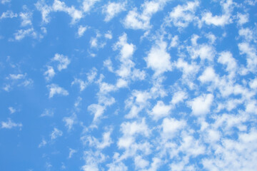 Beautiful small white clouds against the blue sky, copy space. Blue sky with clouds, free space. Clouds transition with a gradient. Texture. The background.