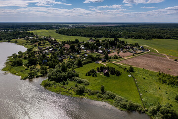panoramic view from the drone to the village of a large lake and forest and fields and roads 