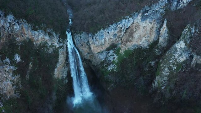 Scenic aerial view of Bliha waterfall with mountain cliff in Bosnia, top down drone shot