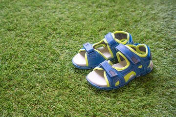 Children's sandals on artificial turf