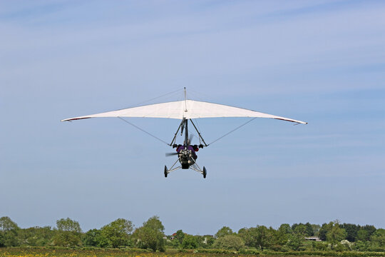 Ultralight airplane flying in a blue sky	