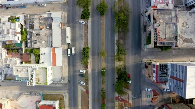 Aerial view of the street intersection with cars driving down the street.