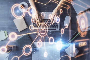 Double exposure of woman hands working on computer and social network theme hologram drawing. Top View. People connection concept.