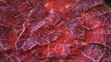 Close up full plate sliced red and fat beef meat Asian style food preparation