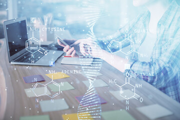 Double exposure of woman hands typing on computer and DNA hologram drawing. Medical education concept.