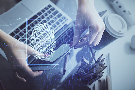 Double exposure of woman hands typing on computer and fingerprint drawing. Security concept.