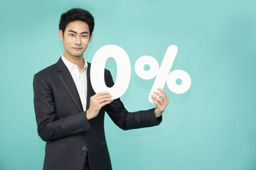 Portrait of Asian business man showing and holding 0% number or zero percent isolated over green background