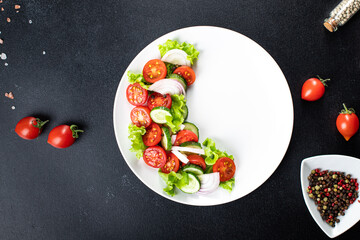fresh salad vegetables tomato, cucumber, onion, lettuce organic dish on the table healthy food meal snack copy space food background rustic. top view keto or paleo diet veggie vegan or vegetarian