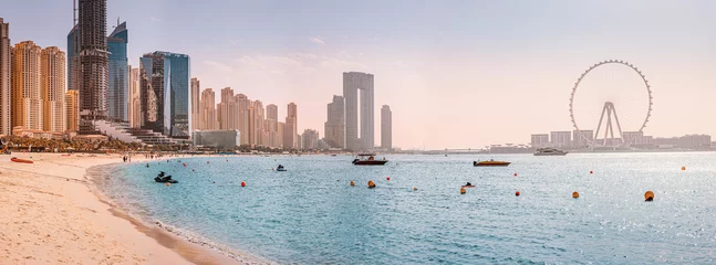 Foto auf Acrylglas Panoramic views of the Persian Gulf beach and Bluewaters Island with the worlds famous largest Ferris wheel Dubai Eye and numerous skyscrapers with hotels and residences © EdNurg