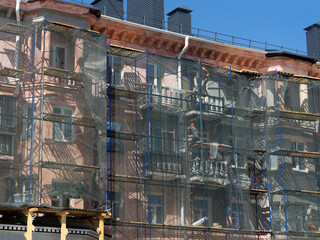 Fototapeta premium Scaffolding around a building, renovating facade building.