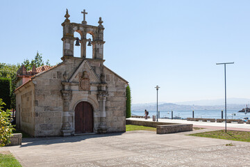 Fototapeta na wymiar Parroquia, Iglesia Capilla del Hospital, situada al lado del paseo maritimo de Cangas en la provincia de Pontevedra, Galicia, España