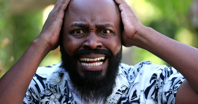 African man reacting with SHOCK and TERROR. Surprised emotion, unbelief