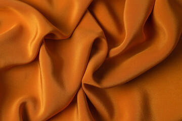 Golden silk or satin luxury fabric texture can use as abstract background.