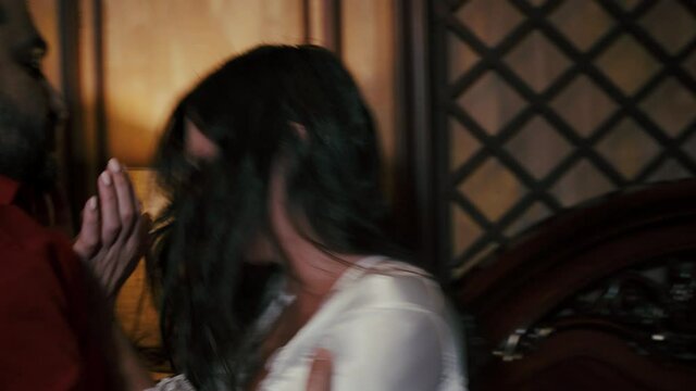 A man and an attractive woman in a negligee are quarreling in the bedroom.