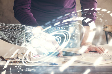 Double exposure of man's hand holding and using a digital device and data theme drawing. Technology...