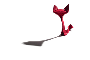 Origami paper cats over a white background with long shadow