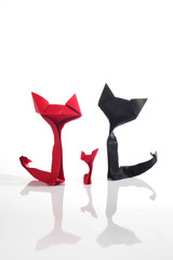 Origami cats over white background