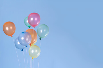 A group of colorful balloons with blue background