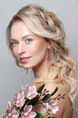 Portrait of gorgeous young woman. Beautiful model with flowers. Cosmetology and beauty spa. Woman skin care photo