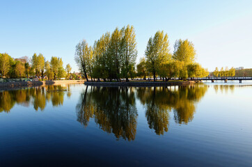 Beautiful landscape photo of embankment in the Taras Shevchenko Park in Ternopil. Trees reflected...