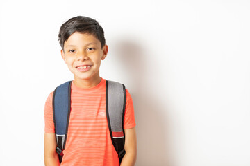 Smiling and excited child holding his school bag ready for the start of school. Back to school concept