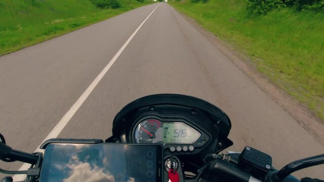 Motorcycle riding on the asphalt road, summer moto traveling, moto adventure concept, first person point of view, pov touring