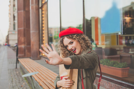 Portrait of smiling young woman with curly hair, happy fashion woman street pictures