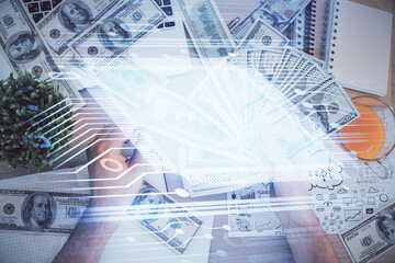 Multi exposure of technology drawing hologram and us dollars bills and man hands. Data concept
