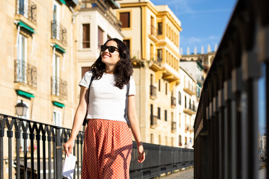 Young happy tourist woman visiting the Old Town in Donostia, Spain