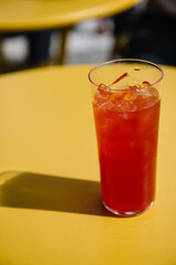 lemonade with ice on yellow table on summer terrace. refreshment summer cold drink