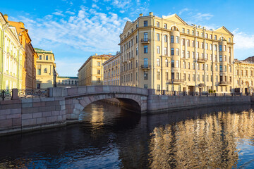 Fototapeta na wymiar Canals of Saint Petersburg. Architecture of Russia. Bridge over the canal in Saint Petersburg. Winter bridge on a summer day. Panorama of Saint Petersburg with a bridge. Guide to Russia.