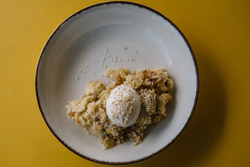 apple crumble with sesame seeds and ice cream bowl