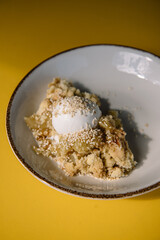 apple crumble with sesame seeds and ice cream bowl