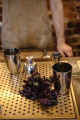 basil leafs on bar table as a future ingredient of the refreshment summer cocktail.