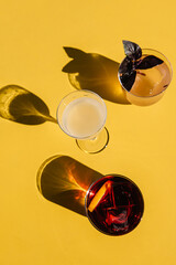 refreshment cocktails on the yellow table. top view with shadows