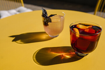 refreshment cocktails on the yellow table. top view with shadows
