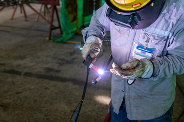 Welder is working welding pipe carbon with process Tungsten Inert Gas Welding (TIG) or Gas Tungsten...