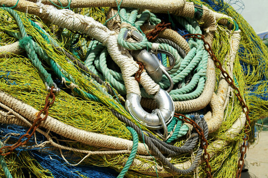 Fishing tackle waiting in the harbour with fishnet and coluor ropes