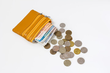 yellow wallet with paper money and coins
