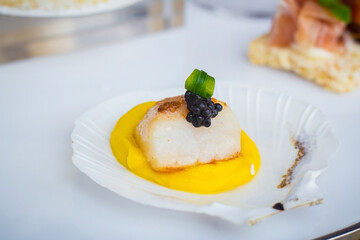 Scallop was served with yellow pumpkin cream sauce and on top with black caviar which put on shell.