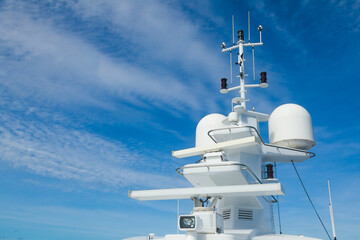 The mast of a large yacht with navigation equipment bottom view. Radar, signal lights, satellite...